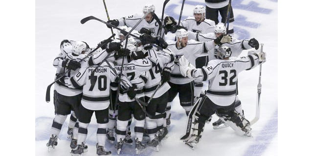 June 1, 2014: The Los Angeles Kings celebrate after defeating Chicago Blackhawks 5-4 in overtime in Game 7 of the NHL Western Conference finals in Chicago. (AP Photo/Charles Rex Arbogast)