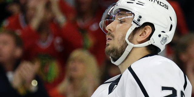 FILE - In this May 18, 2014, file photo, Los Angeles Kings' Slava Voynov reacts during the second period in Game 1 of the Western Conference finals in the NHL hockey Stanley Cup playoffs in Chicago. Voynov has been charged with felony domestic violence. The Los Angeles County district attorney’s office announced the charge Thursday, Nov. 20, 2014. Voynov faces one felony count of corporal injury to a spouse with great bodily injury. The district attorney’s office says Voynov “caused his wife to suffer injuries to her eyebrow, cheek and neck” during an argument. (AP Photo/Nam Y. Huh, File)