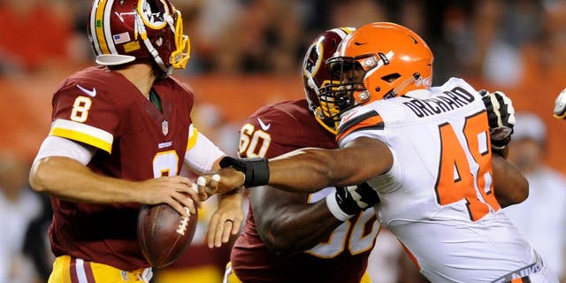 Aug 13, 2015; Cleveland, OH, USA; Cleveland Browns linebacker Nate Orchard (48) gets a hand on Washington Redskins quarterback Kirk Cousins (8) as Washington Redskins tackle Willie Smith (60) blocks during the second quarter in a preseason NFL football game at FirstEnergy Stadium. Mandatory Credit: Ken Blaze-USA TODAY Sports