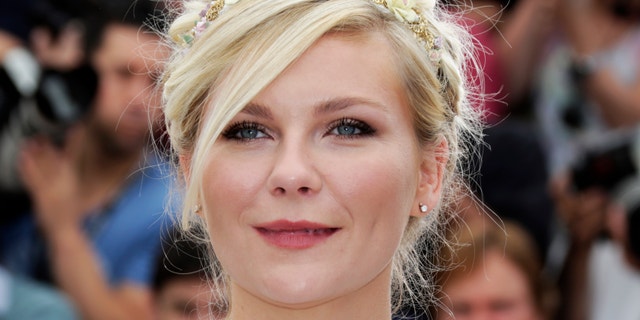 Cast member Kirsten Dunst poses during a photocall for the film "On The Road", in competition at the 65th Cannes Film Festival, May 23, 2012.