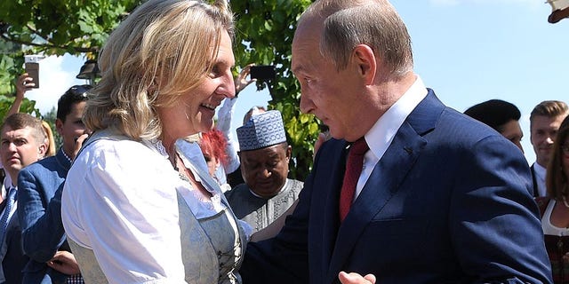 Austria's foreign minister Karin Kneissl and Russian President Vladimir Putin at her wedding Saturday.