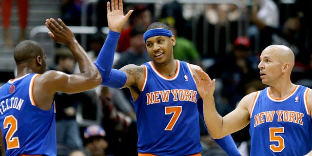New York Knicks' Carmelo Anthony, center, high-fives teammates Raymond Felton, left, and Jason Kidd after the Knicks beat the Atlanta Hawks 95-82 in an NBA basketball game, Wednesday, April 3, 2013, in Atlanta. (AP Photo/David Goldman)