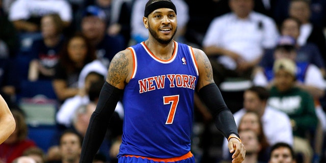 New York Knicks small forward Carmelo Anthony (7) smiles after scoring during the second half of an NBA basketball game against the New Orleans Pelicans in New Orleans, Wednesday, Feb. 19, 2014. The Knicks won 98-91. (AP Photo/Jonathan Bachman)