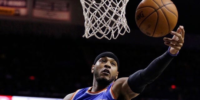 New York Knicks' Carmelo Anthon reaches for a rebound against the San Antonio Spurs during the first half on an NBA basketball game, Thursday, Jan. 2, 2014, in San Antonio. (AP Photo/Eric Gay)