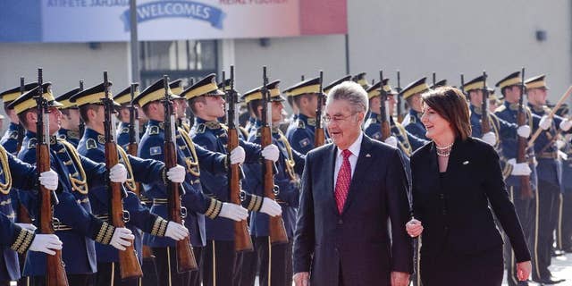 Kosovo President Atifete Jahjaga, right, flanked by Austrian President Heinz Fischer inspecting the honour guard of the Kosovo Security Force, during a welcoming ceremony in Kosovo capital Pristina on Wednesday, Oct. 28, 2015. The Austrian President Heinz Fischer is in a two-day official visit in Kosovo. (AP Photo/Visar Kryeziu)