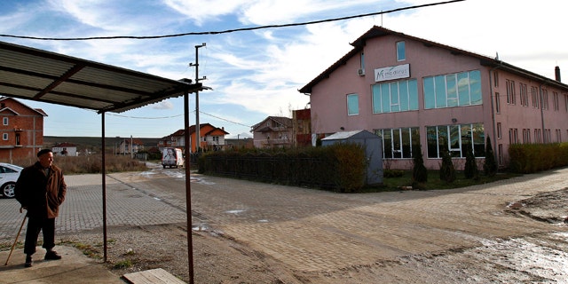 Nov. 12: An elderly man stands outside the Medicus private medical clinic in Kosovo's capital Pristina.