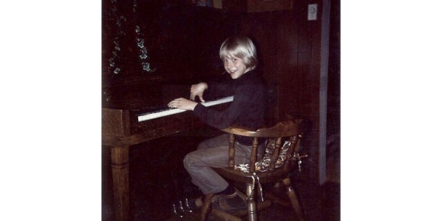 September 24, 2013: In this undated photo provided by Kim Cobain, a young Kurt Cobain plays piano in his childhood home in Aberdeen, Wash. Cobain's mother, Wendy O'Connor, is putting the 1.5-story Aberdeen bungalow, which is assessed at less than $67,000, on the market for $500,000. But she'd also be happy entering into a partnership with anyone who wants to turn it into a museum. (AP Photo)