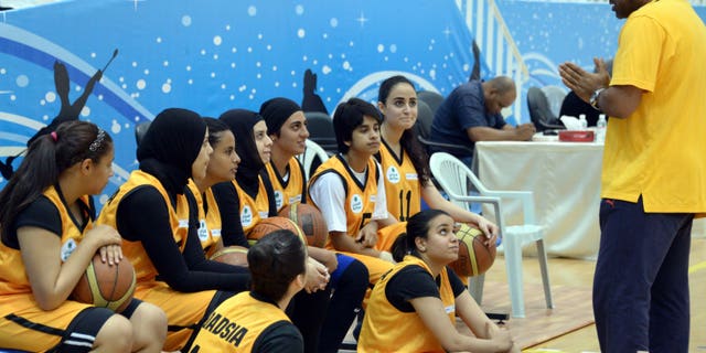 May 9, 2013: Kuwait's Qadsiya Club women basketball team listen to their coach, during the Women's Games, at Salwa Al Sabah Sports Center in Qurein, Kuwait. The event is part of a new initiative launching sports leagues for women, including basketball, table tennis and athletic leagues for the first time in Kuwait illustrating how the landscape for women athletes is improving across the Persian Gulf where hard-liners have long opposed women playing sports.