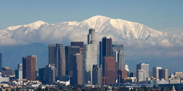 LOS ANGELES, CA - JANUARY 7: Fresh snow blankets the mountains behind the downtown skyline after a series of storms that hammered northern California delivered much needed precipitation to the Greater Los Angeles Area January 7, 2008 in Los Angeles, California. With the threat of mandatory water rationing still in effect because of prolonged drought, the rain is a small step toward relief. Forecasters had predicted flash floods and mudslides near large areas that were denuded by wildfires of historic proportions in October, and some mandatory evacuations were declared, but little damage was reported. (Photo by David McNew/Getty Images)