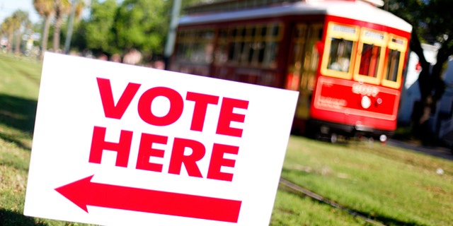 NEW ORLEANS, LA - MARCH 24: A street car pases a voting station along St. Charles Avenue during the state Republican primary on March 24, 2012 in New Orleans, Louisiana. Voters go the polls to pick a candidate with 20 delegates up for grabs. (Photo by Sean Gardner/Getty Images)