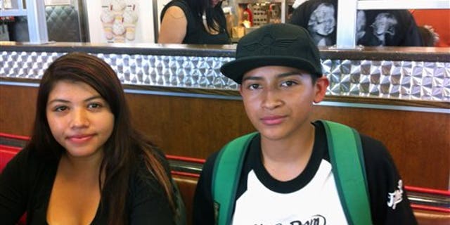 This Oct. 1, 2013 photo showing Roosevelt High School students Carlos Espinoza and Maria Aguilera talk during an interview in Los Angeles. They were among two of the Los Angeles Unified School District's 650,000 students to receive iPads under a district plan to supply every student and teacher with one of the tablets by next year. Espinoza says he quickly cracked the iPad's security settings and used it to go on Facebook. Aguilera says district officials shouldn't have been surprised that hundreds of high school students would do that. (AP Photo/John Rogers)