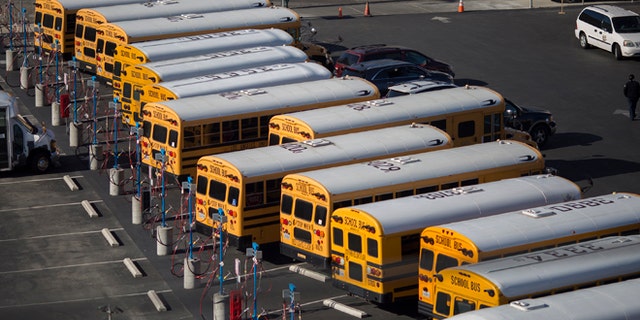 School buses stand idle as all Los Angeles city schools are shut down in reaction to a threat on December 15, 2015 in Los Angeles, California. (Photo by David McNew/Getty Images)