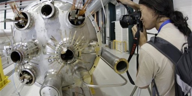 Aug. 7, 2010: An amateur photographer takes a picture in the assembly room of the elements of the LHC (large hadron collider) during the Particle Physics Photowalk at the European Particle Physics laboratory (CERN) in Geneva, Switzerland.