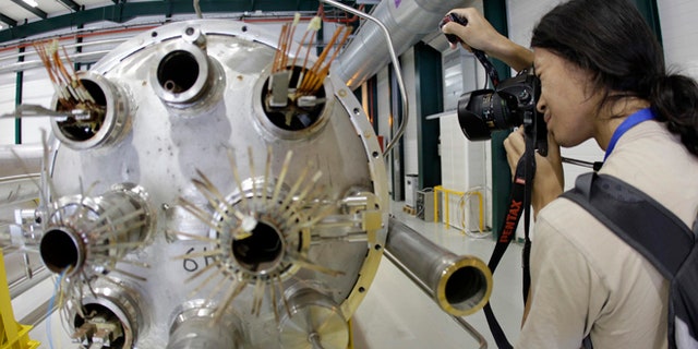 Aug. 7, 2010: A photographer takes a picture in the assembly room of the elements of the LHC (large hadron collider) at the European Particle Physics laboratory CERN in Geneva, Switzerland The world's biggest particle accelerator is about to start up again after a two-year shutdown and upgrade.