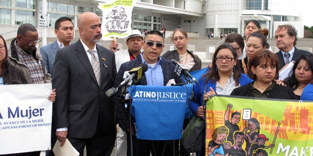 Joselo Lucero, center, the brother of an Ecuadorean immigrant killed by a group of Long Island teenagers in 2008, speaks at a press conference, Thursday, April 30, 2015, outside the U.S. District Courthouse in Central Islip, N.Y. Lucero joined advocates for Latinos in announcing a lawsuit that Latinos were unjustly targeted for traffic stop by members of Suffolk County's police department. (AP Photo/Frank Eltman)