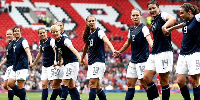July 31, 2012: United States' Abby Wambach (14) celebrates with teammates after scoring against North Korea during their group G women's soccer match at the London 2012 Summer Olympics, at Old Trafford Stadium in Manchester, England.