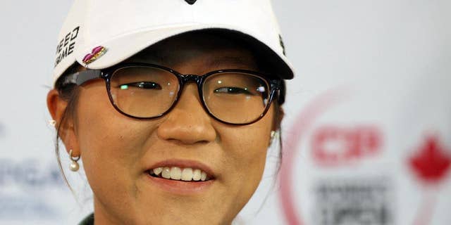 FILE - This is an Aug. 20, 2014, file photo showing Lydia Ko answering questions at the Canadian Pacific Women's Open golf tournament in London, Ontario. Ko has become the youngest player to win the LPGA Tour's rookie of the year award. The 17-year-old Ko clinched the points-based award with three tournaments remaining on the LPGA Tour schedule. (AP Photo/The Canadian Press, Dave Chidley, File)