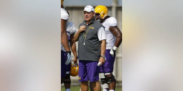 FILE - In this Aug. 6, 2014, file photo, LSU head coach Les Miles runs drills during their NCAA college football practice in Baton Rouge, La. Miles has yet to announce a starting quarterback and it remains to be seen how much of a role freshman running back Leonard Fournette will have in the offense. (AP Photo/Gerald Herbert, File)