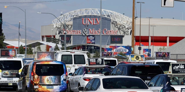 Cars drive along a road near the UNLV campus, Monday, Oct. 17, 2016, in Las Vegas. Traffic will be a major issue along the Las Vegas Strip and near UNLV as streets and a freeway close for security during the presidential debate at UNLV on Wednesday. (AP Photo/John Locher)