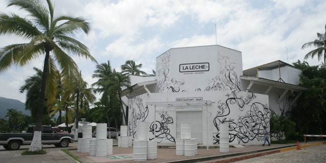The entrance of the restaurant "La Leche" stands closed after armed men abducted as many as 16 people who were dining in the upscale restaurant in Puerto Vallarta, Mexico, Monday, Aug. 15, 2016. Jalisco state prosecutor Eduardo Almaguer said in a news conference that preliminary results of the investigation indicate that all involved, kidnappers and kidnapped, were members of criminal organizations. (AP Photo/David Diaz)