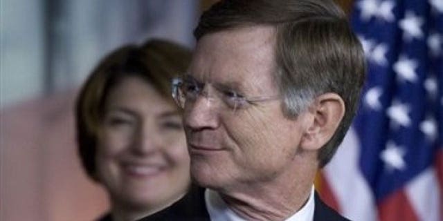 May 26, 2011: Rep. Lamar Smith, R-Texas, right, accompanied by Rep. Cathy McMorris Rodgers, R-Wash. smiles during a news conference on Capitol Hill in Washington.