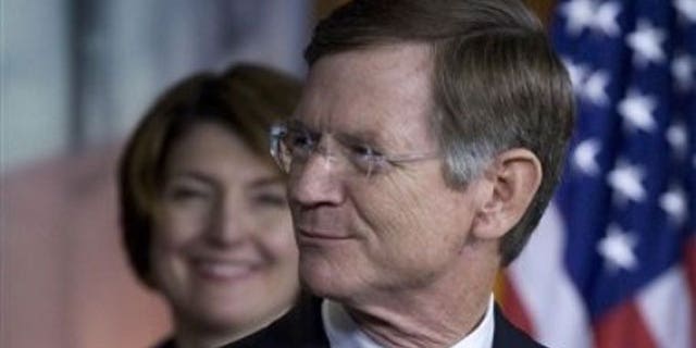 May 26, 2011: Rep. Lamar Smith, R-Texas, right, accompanied by Rep. Cathy McMorris Rodgers, R-Wash. smiles during a news conference on Capitol Hill in Washington.