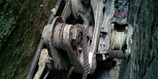 This Friday, April 26, 2013, photo provided by the New York City Police Department shows a piece of landing gear that authorities believe belongs to one of the airliners that crashed into the World Trade Center on Sept. 11, 2001, that was found wedged between a mosque and another building, in New York. Police say the medical examiner's office will complete a health and safety evaluation to determine whether to sift the soil around the buildings for possible human remains. (AP Photo/New York City Police Department)