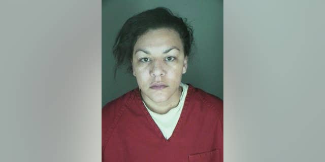 This undated booking photo provided by the Longmont Police Department shows Dynel Lyne, 34, who is accused of stabbing a pregnant woman in the stomach and removing her baby, while the expectant mother visited her home to buy baby clothes advertised on Craigslist authorities said. The 26-year-old expectant mother was found beaten and stabbed at the suspect's home, has undergone surgery, and on Thursday was alert, police said. The baby did not survive. (AP Photo/ Longmont Police Department)