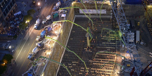 February 15, 2014: Crews pour concrete to lay the foundation for the New Wilshire Grand building in a record attempt for the largest continuous concrete pour in history in downtown Los Angeles. The marathon pour is expected to last 20 hours without interruption. (AP Photo/Mark J. Terrill)
