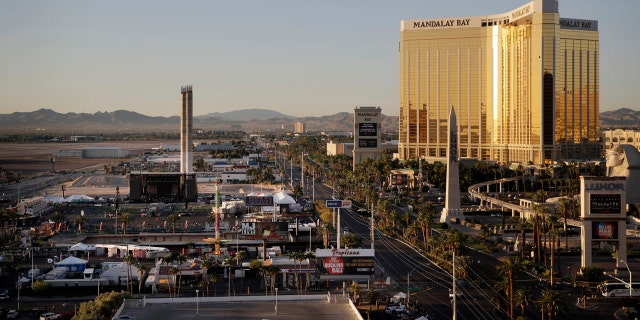 The Mandalay Bay resort and casino, right, overlooks an outdoor festival grounds across the street, left, Tuesday, Oct. 3, 2017, in Las Vegas. Authorities said Stephen Craig Paddock broke the windows on the casino and began firing with a cache of weapons, killing dozens and injuring hundreds at a music festival at the grounds. (AP Photo/John Locher)