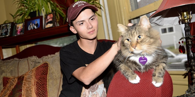 Sept. 10, 2014: In a file photo, Draven Rodriguez and his cat Mr. Bigglesworth at their home in Schenectady, N.Y. (AP/The Daily Gazette, Patrick Dodson)