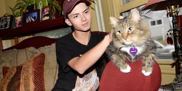 Sept. 10, 2014: In a file photo, Draven Rodriguez and his cat Mr. Bigglesworth at their home in Schenectady, N.Y. (AP/The Daily Gazette, Patrick Dodson)
