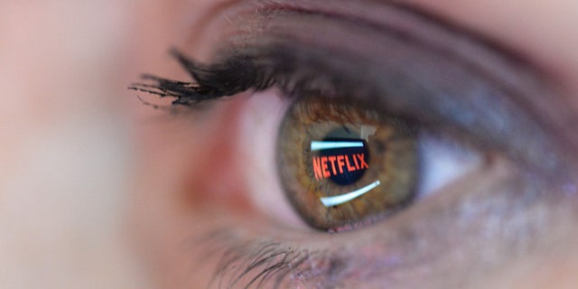 File photo:In this photo illustration the Netflix logo is reflected in the eye of a woman on September 19, 2014 in Paris, France. (Photo by Pascal Le Segretain/Getty Images)