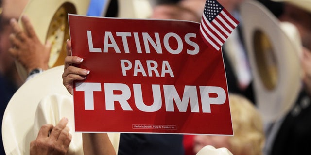 CLEVELAND, OH - JULY 21: A delegate holds up sign that reads "Latinos Para Trump" during the evening session on the fourth day of the Republican National Convention on July 21, 2016 at the Quicken Loans Arena in Cleveland, Ohio. Republican presidential candidate Donald Trump received the number of votes needed to secure the party's nomination. An estimated 50,000 people are expected in Cleveland, including hundreds of protesters and members of the media. The four-day Republican National Convention kicked off on July 18. (Photo by Jeff Swensen/Getty Images)