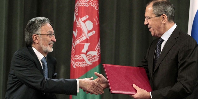 Nov. 25: Russia's Foreign Minister Sergei Lavrov, right, shakes hands with his Afghan counterpart Zalmay Rasul during a signing ceremony in Moscow, where Lavrov said Russia will allow NATO to take armored vehicles to Afghanistan through its territory under an expanded transit deal.