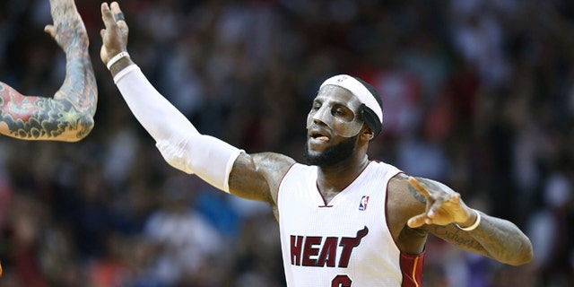 Miami Heat's LeBron James celebrates afer scoring two points with Chris Andersen during the second half of an NBA basketball game in Miami, Monday, March 3, 2014 against the Charlotte Bobcats. LeBron James scored a team recond of 61 points. The Heat won 124-107. (AP Photo/J Pat Carter)