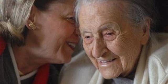 In a 2008 photo, Dr. Leila Denmark, right, listens to her grand niece Jackie Bennett as she celebrates her 110th birthday, in Athens, Ga. (AP Photo/Athens Banner Herald, Trevor Frey)