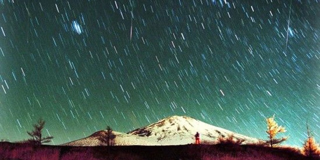 Leonid meteors are seen streaking across the sky over snow-capped Mount Fuji, Japan's highest mountain, early Monday Nov. 19, 2001, in this 7-minute exposure photo. Star gazers braved cold temperatures at the foot of Mount Fuji to observe the shower of Leonid meteors.