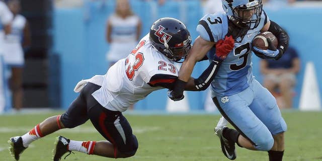 North Carolina's Ryan Switzer (3) runs the ball as Liberty's Justin Guillory (23) moves in to make the tackle during the first half of an NCAA college football game in Chapel Hill, N.C., Saturday, Aug. 30, 2014. (AP Photo/Gerry Broome)