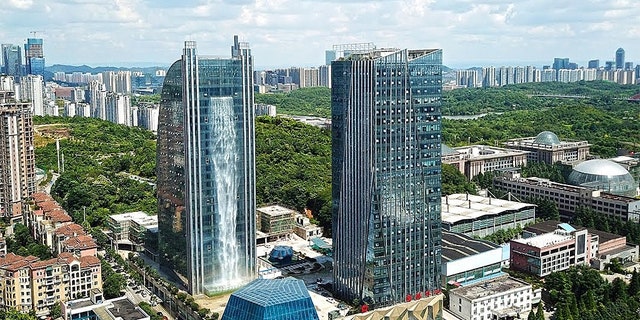 The Liebian Building is southwest China features a waterfall on its side.
