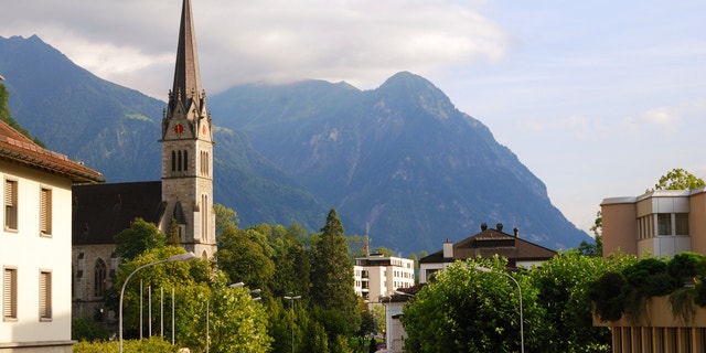 Vaduz church, street and Alps, Liechtenstein, panoramic view