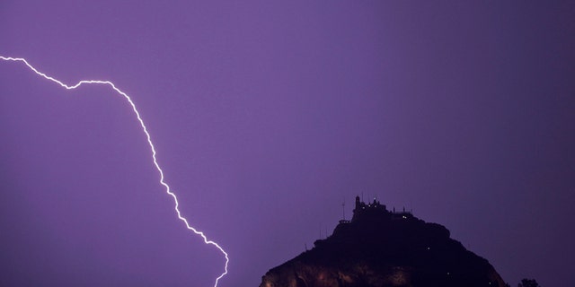File photo - Lightning strikes over Lycabettus hill in Athens, October 24, 2014.