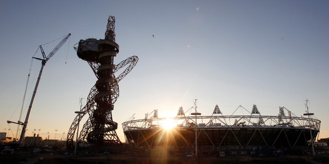 The London 2012 Olympic Stadium is seen at about sunset, with the partially completed ArcelorMittal Orbit at the Olympic Park in London.