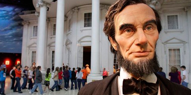 Feb. 10, 2012: School students enter the "White House" as a life size Abraham Lincoln replica stands outside, while touring the Abraham Lincoln Presidential Library and Museum with classmates in Springfield, Ill.