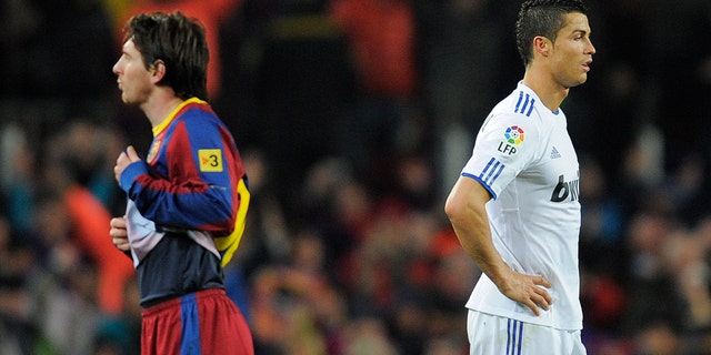 BARCELONA, SPAIN - NOVEMBER 29: Cristiano Ronaldo of Real Madrid (R) and Lionel Messi of FC Barcelona look on during the La Liga match between Barcelona and Real Madrid at the Camp Nou Stadium on November 29, 2010 in Barcelona, Spain. Barcelona won the match 5-0. (Photo by David Ramos/Getty Images)