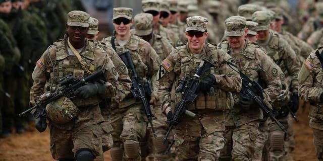 FILE - In this Thursday, Nov. 13, 2014 file photo, members of the U.S. Army B Company, 2nd Battalion, 8th Cavalry Regiment, 1st Brigade Combat Team, 1st Cavalry Division attend a military exercise 'Iron Sword 2014', at the Gaiziunu Training Range in Pabrade some 60km.(38 miles) north of the capital Vilnius, Lithuania. The U.S. military's European Command said Tuesday, Nov. 18 it has ordered its troops to avoid wearing their uniforms when off base, and to ensure the security settings and geolocation functions on their social media pages aren't "overly revealing." EUCOM spokesman Navy Capt. Greg Hicks would not say what prompted the new directive for the roughly 70,000 U.S. personnel serving in Europe. The order, issued Nov. 10, comes after high-profile attacks on soldiers of American allies Britain and Canada in their home countries. (AP Photo/Mindaugas Kulbis, file)