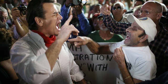 Argument over the normalization of relations between the U.S. and Cuba outside the Little Havana restaurant Versailles on December 17, 2014 in Miami, Florida. (Photo by Joe Raedle/Getty Images)