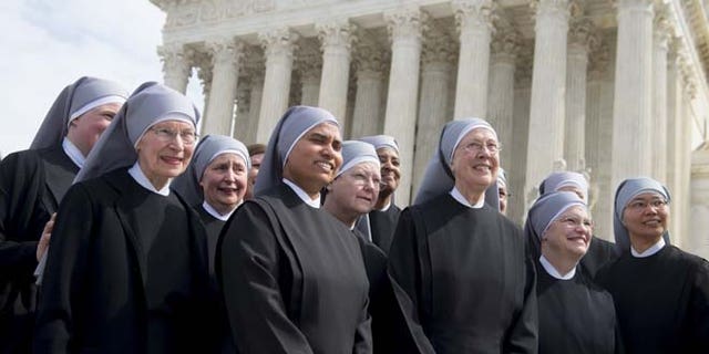 Loraine Marie Maguire (3rd R), mother provincial of the Little Sisters of the Poor, stands alongside fellow nuns following oral arguments in 7 cases dealing with religious organizations that want to ban contraceptives from their health insurance policies on religious grounds at the Supreme Court in Washington, DC, March 23, 2016. / AFP / SAUL LOEB (Photo credit should read SAUL LOEB/AFP/Getty Images)