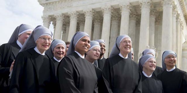 Loraine Marie Maguire (3rd R), mother provincial of the Little Sisters of the Poor, stands alongside fellow nuns following oral arguments in 7 cases dealing with religious organizations that want to ban contraceptives from their health insurance policies on religious grounds at the Supreme Court in Washington, DC, March 23, 2016. / AFP / SAUL LOEB (Photo credit should read SAUL LOEB/AFP/Getty Images)