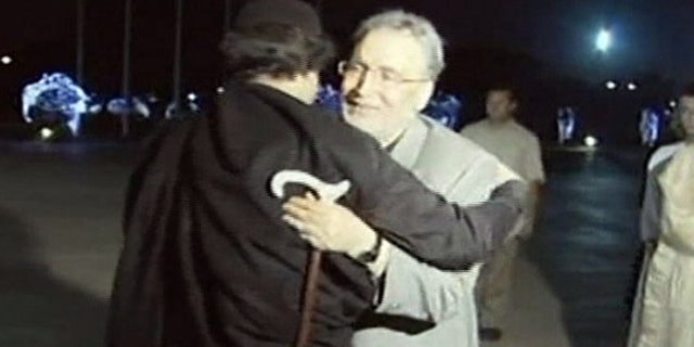 Aug. 21, 2009: In this image made from television, Abdel Baset al-Megrahi, right, who was found guilty of the 1988 Lockerbie bombing, is greeted by Libyan leader Muammar al-Qaddafi in Tripoli, Libya.